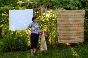 Mother in front of Clothesline. Short Hellos & Long Goodbyes. LipnicaTuzla, BiH. 2017 © Trashbus ǀ Renata Britvec